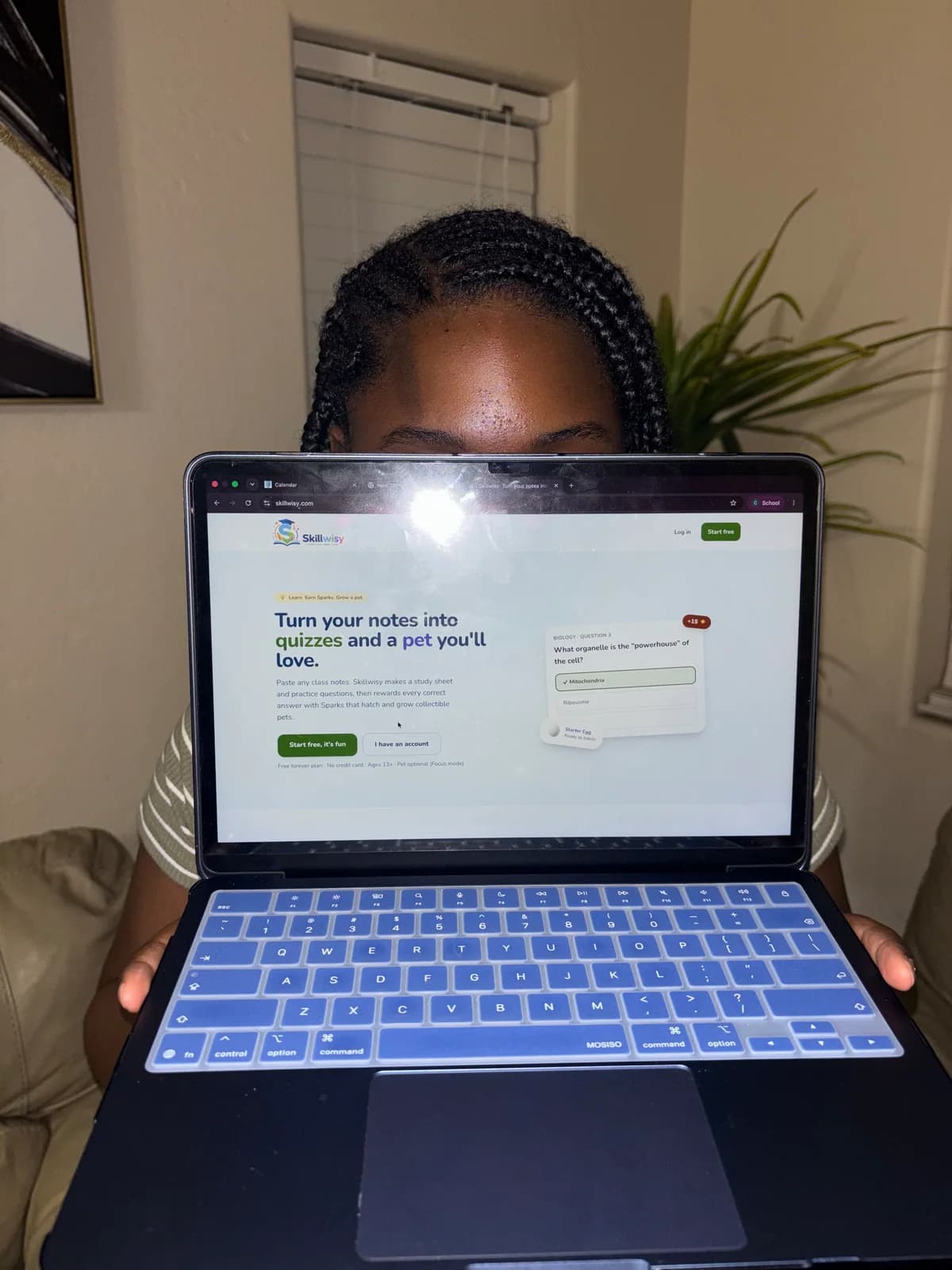Skillwisy’s student creator holding a laptop with the app